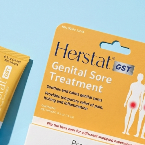 Herstat GST Genital Sore Treatment packaging and tube on a blue background